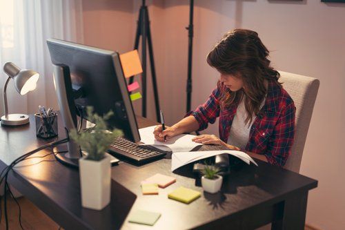 Overtime Compensation Rights — Young Woman Working Late At The Office in Huntsville, AL