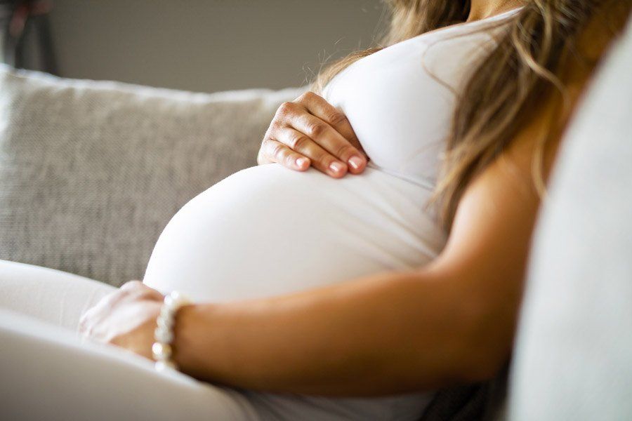 Close-Up of Pregnant Woman Sitting in Sofa — Birmingham, AL — Allen D. Arnold Attorney at Law Close-Up of Pregnant Woman Sitting in Sofa — Birmingham, AL — Allen D. Arnold Attorney at Law