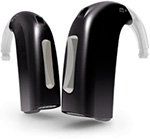 A pair of black hearing aids are sitting next to each other on a white surface.