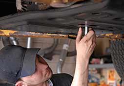 Man Fixing Car — United Middleboro Petroleum Inc in Middleboro, MA Man Fixing Car — United Middleboro Petroleum Inc in Middleboro, MA