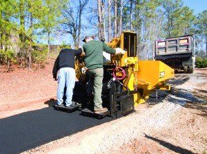 Two Men on Small Asphalt Paver — Kent, WA — Acme Paving & Seal Coating, Inc.