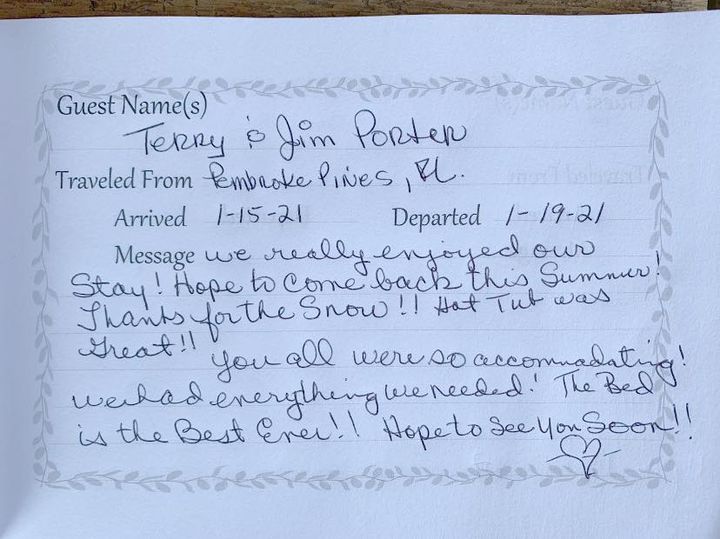 Handwritten guestbook note on lined paper with names, arrival/departure dates, and a thank-you message about a snowy stay