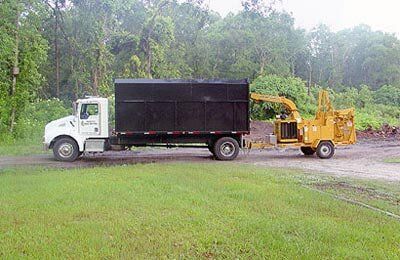 White and black truck service — Tree Removal in Jacksonville, FL