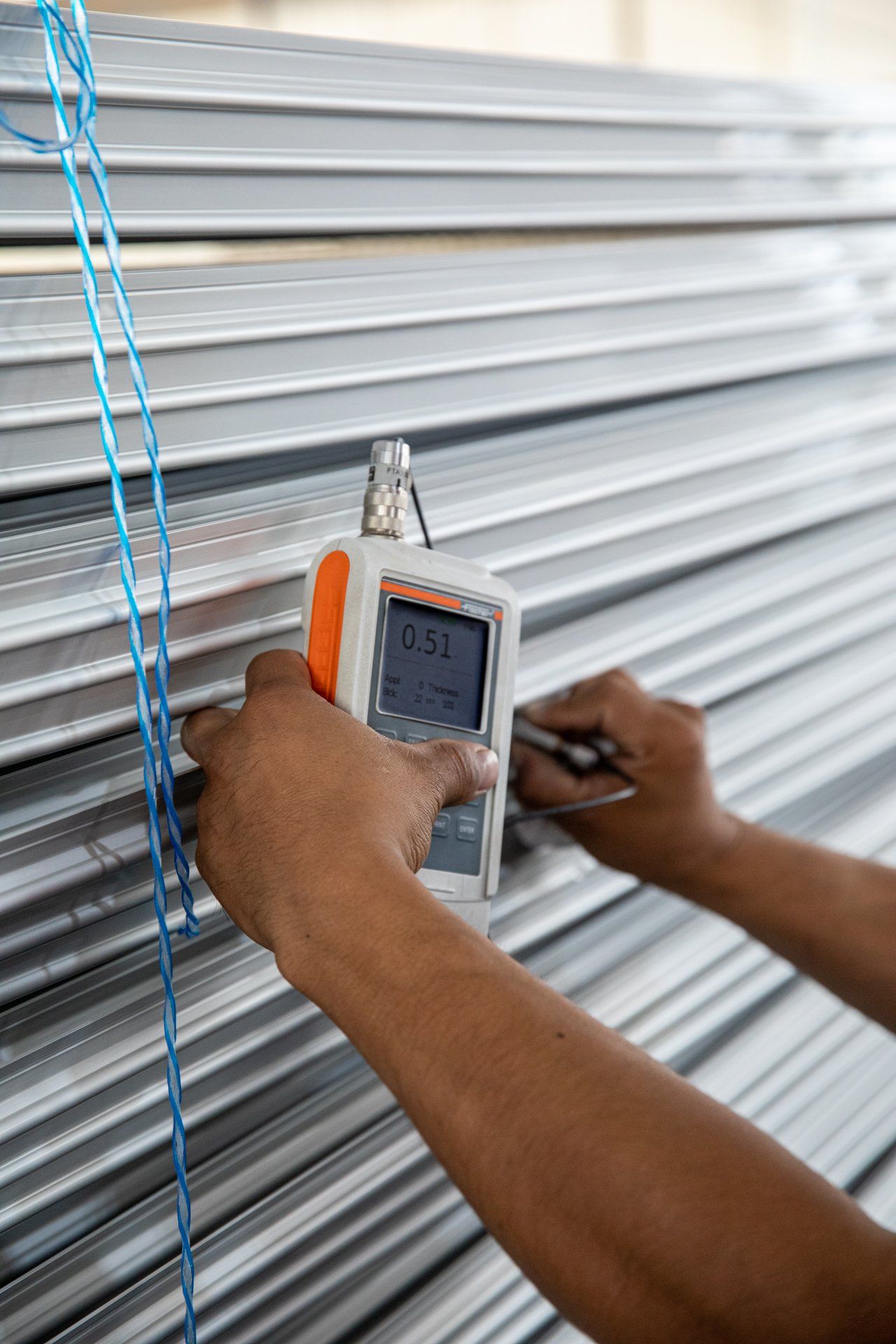 Man using a tool to check the properties of metal
