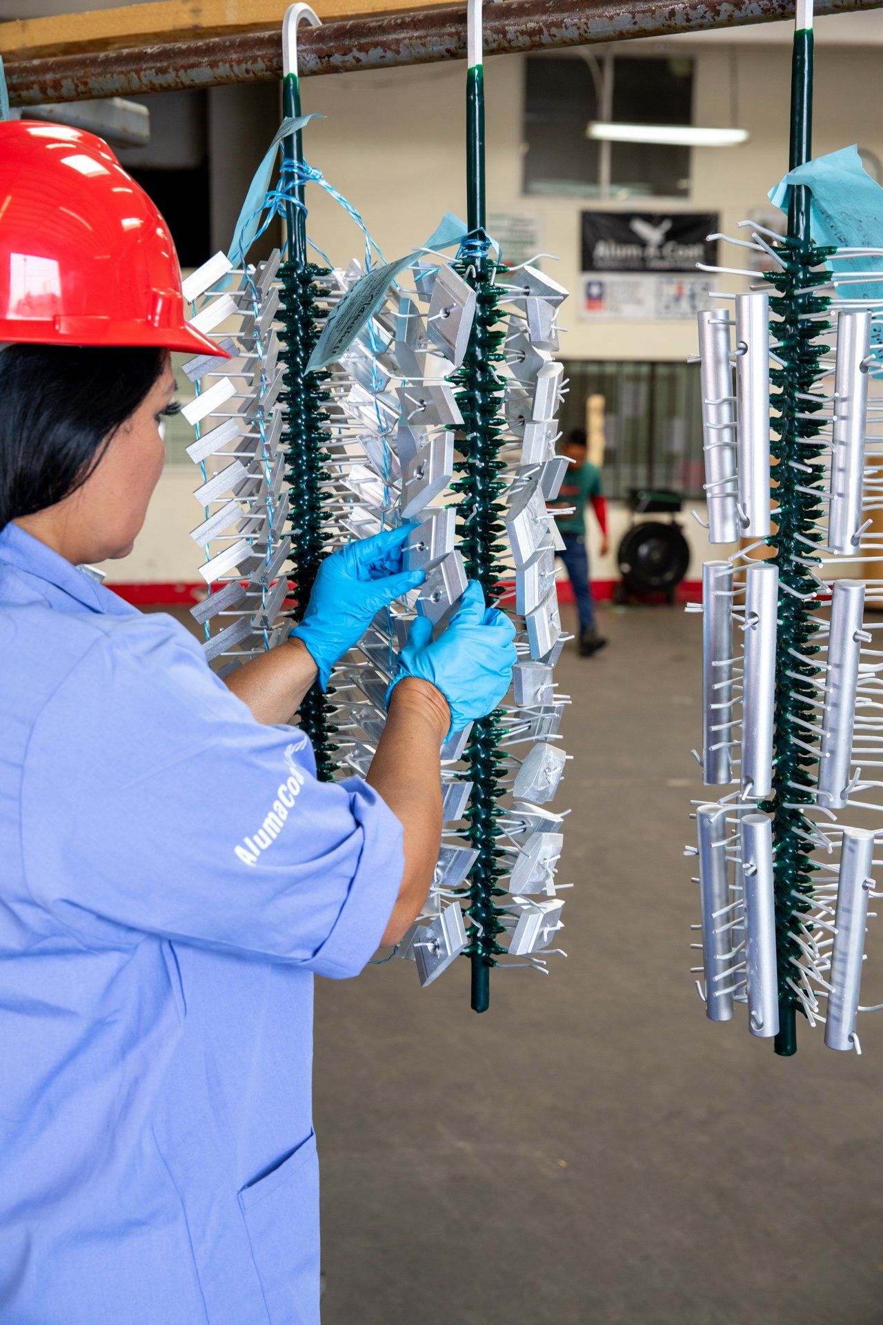woman checking many small pieces of metal