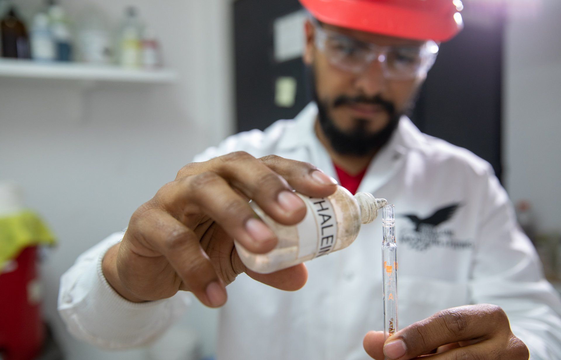 Man with test tube and safety goggles