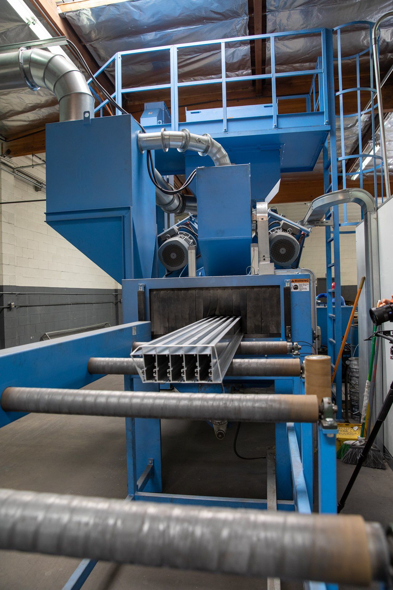 large blue machine pulling in metal