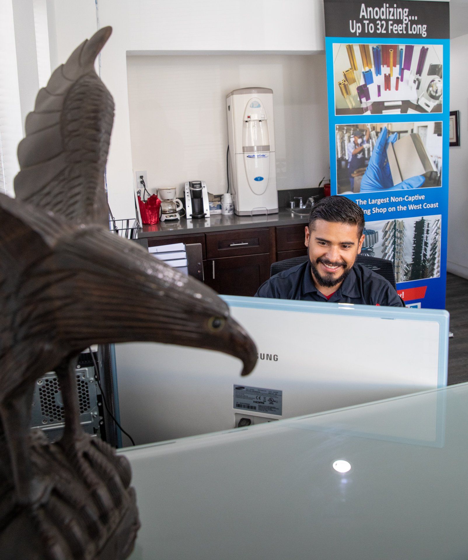 statue eagle standing on desk next to computer