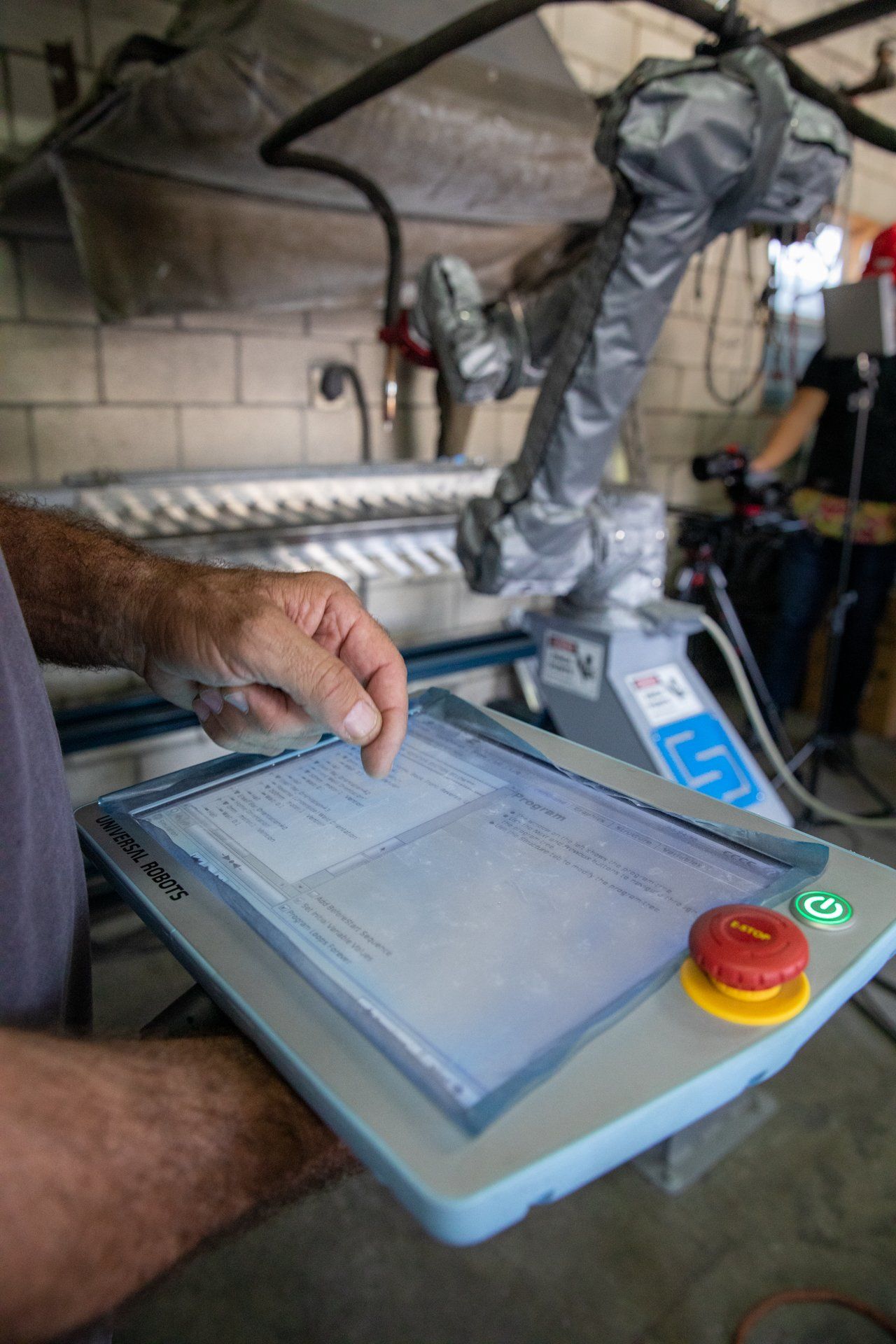 man using touch-screen to control robot