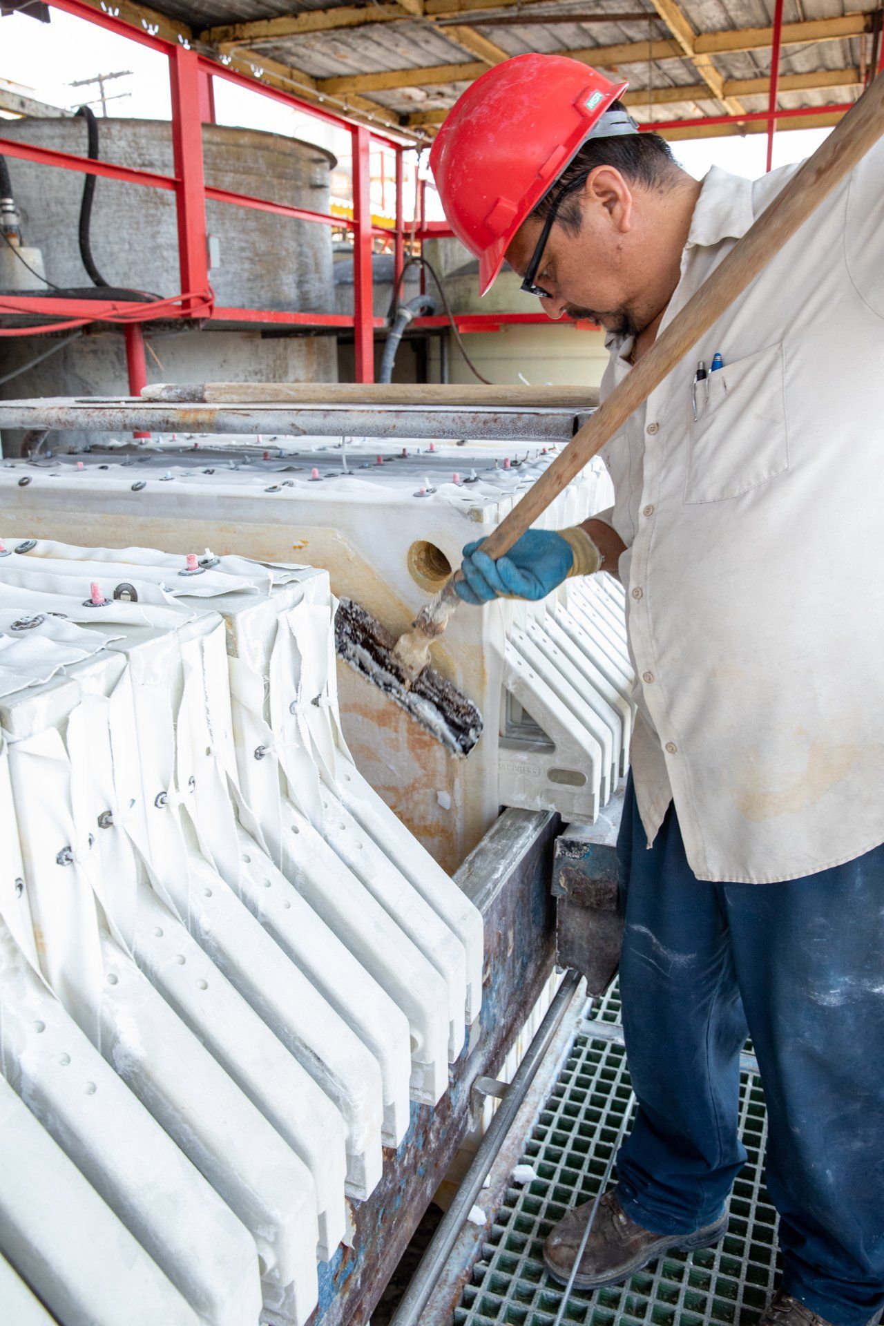 Man working with tool wearing a hard hat