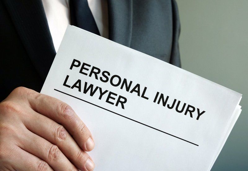 Attorney Holding Personal Injury Document | Fairmont, WV | Higinbotham & Higinbotham, PLLC Attorney Holding Personal Injury Document | Fairmont, WV | Higinbotham & Higinbotham, PLLC