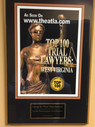 Framed award plaque for “Top 100 Trial Lawyers: West Virginia” with a gold Lady Justice statue.