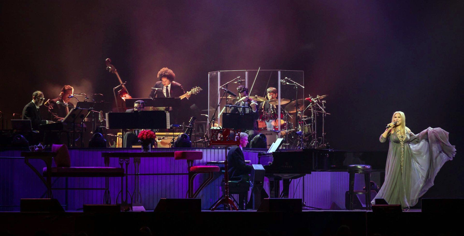 Streisand on stage with band.
