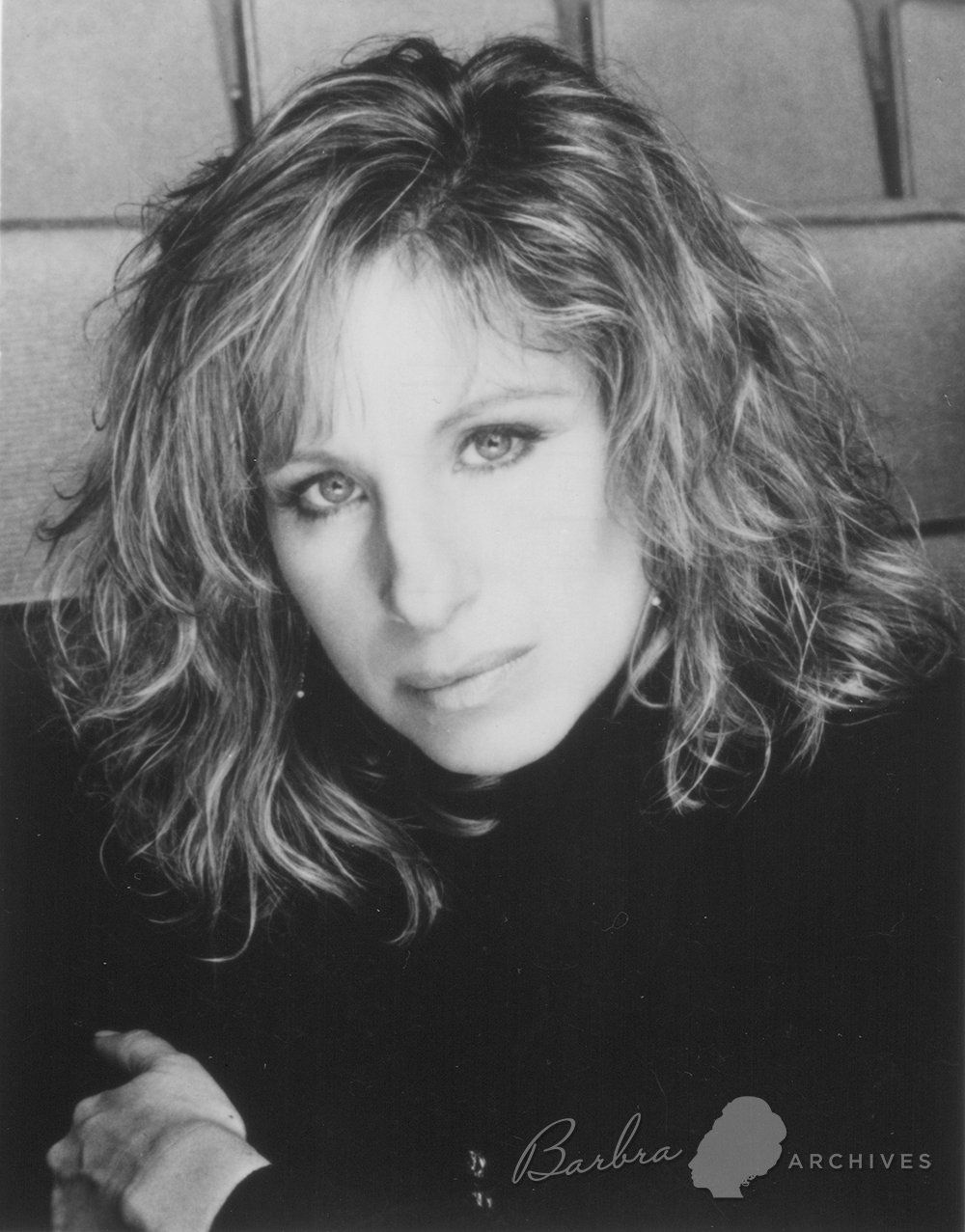 Black & white photo of Streisand in Broadway theater wearing beret by photographer Richard Corman