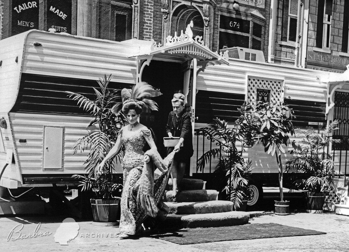 Streisand emerges from her dressing trailer with long train on dress