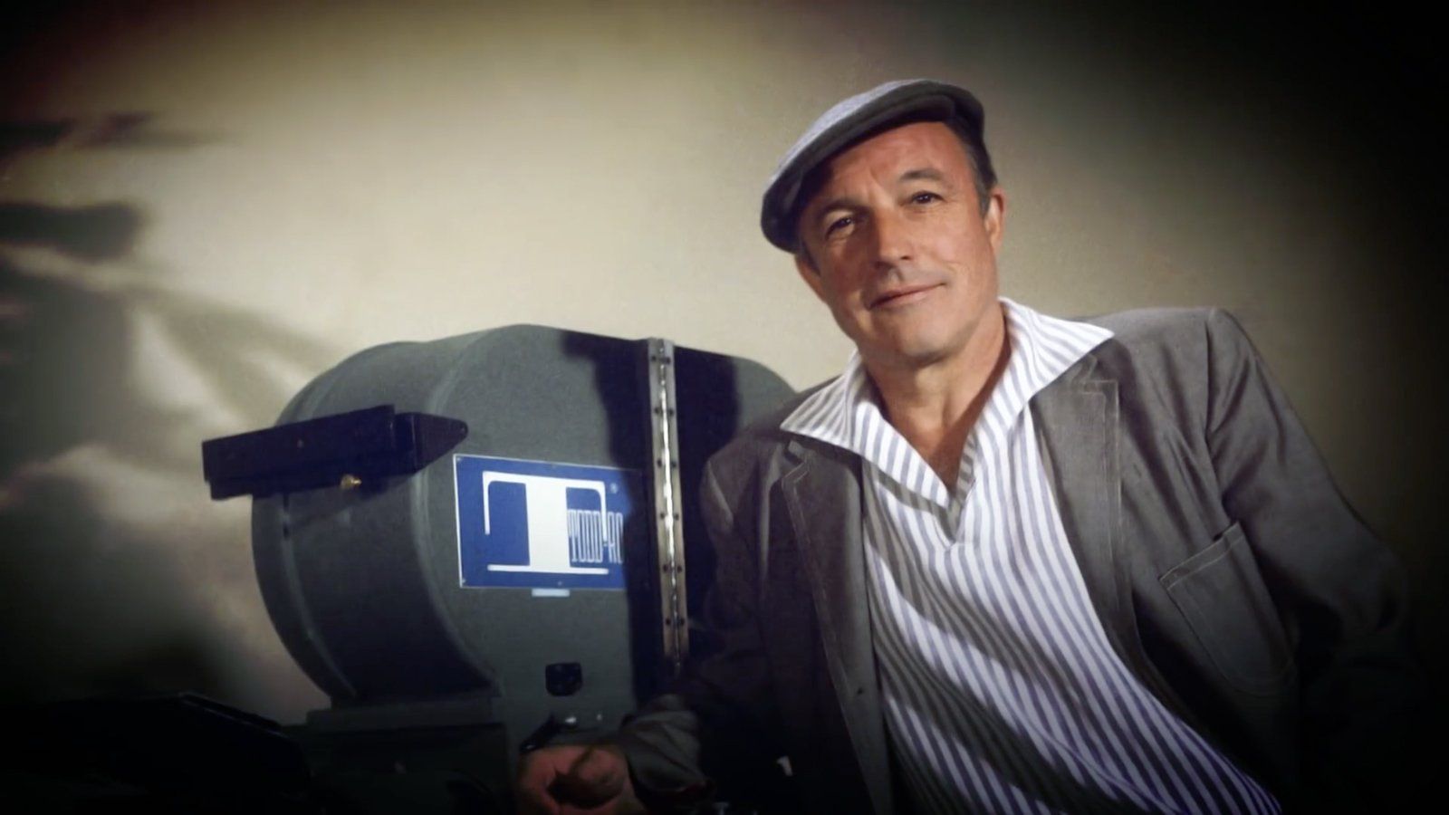 Gene Kelly poses with a large format Todd-AO Camera Gene Kelly poses with a large format Todd-AO Camera
