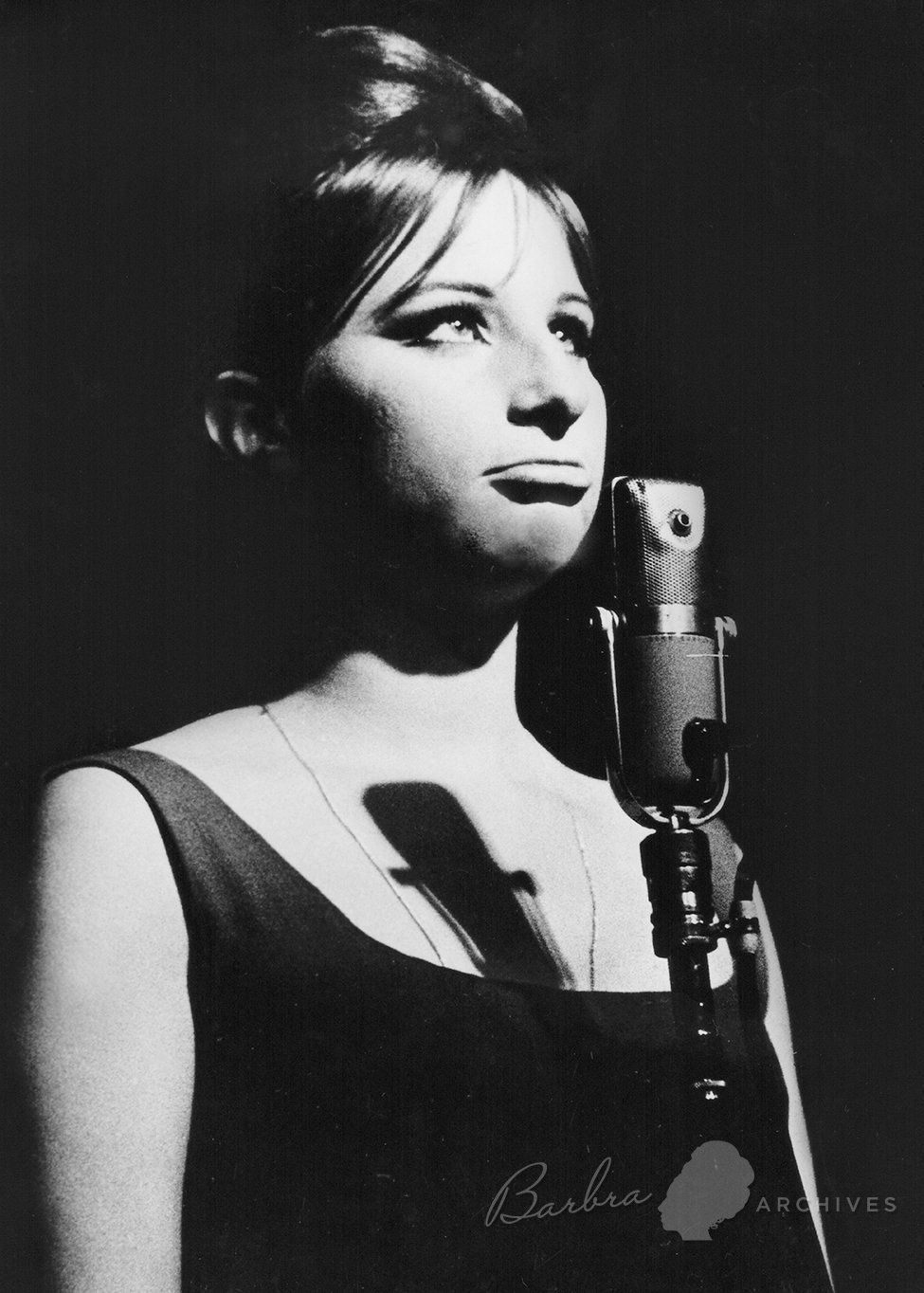 Photo of Barbra Streisand at the microphone at the hungry i. Photo by Grover Sales.