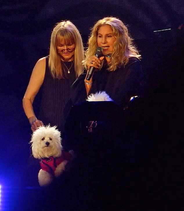 Renata and Barbra onstage, With her small white dog in a tram.