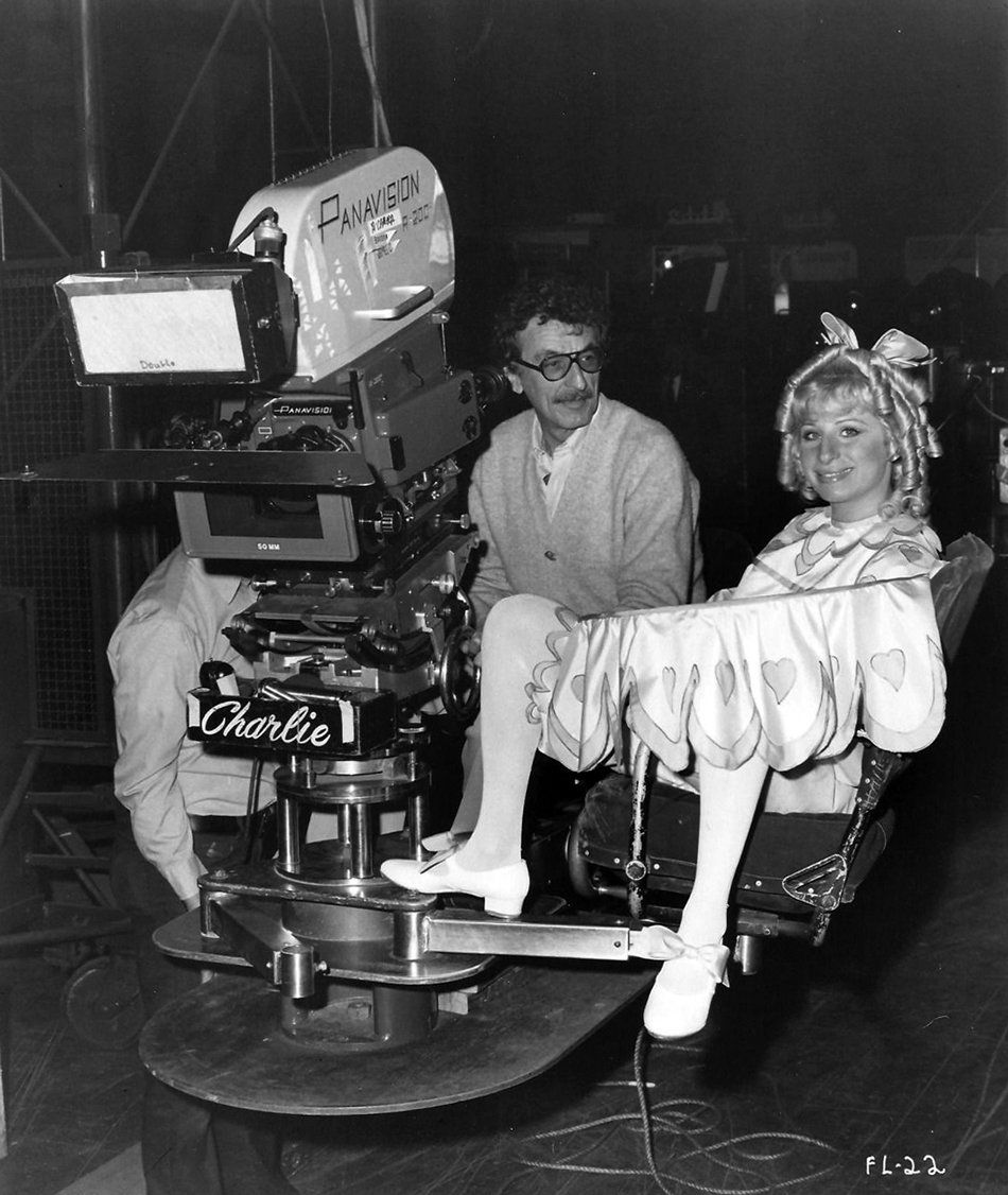 Director Herb Ross and Barbra behind the camera, with Barbra dressed in baby doll 'Baby Snooks' costume with blond curls.
