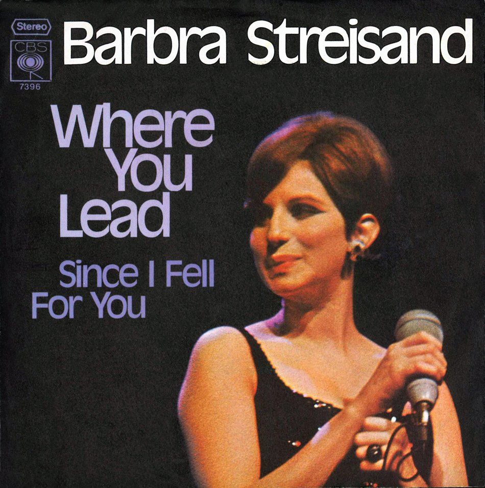 Barbra Streisand album cover with purple text and her holding a microphone on a black background