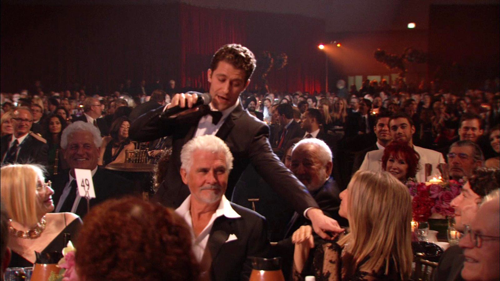 Matthew Morrison serenades Barbra Streisand and James Brolin at their table.