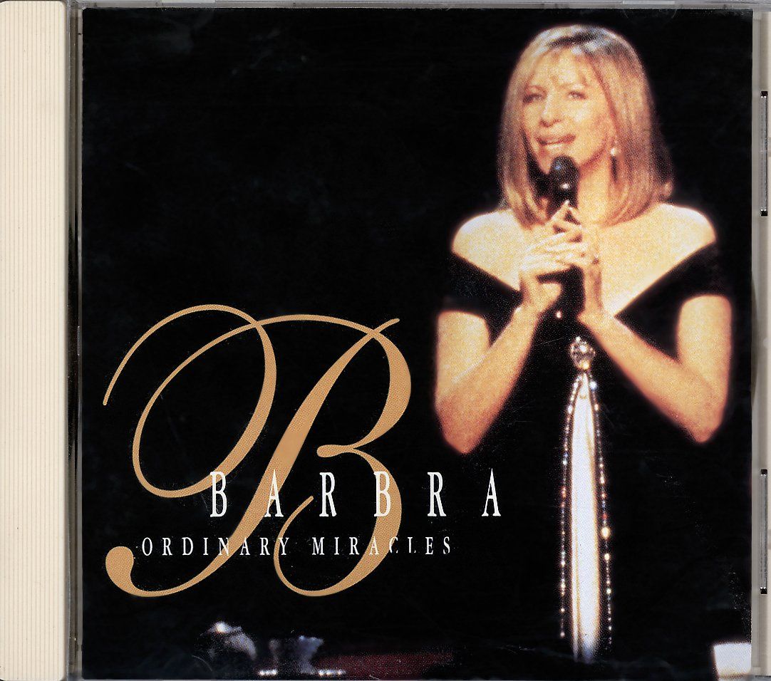 ORdinary Miracles CD cover of Barbra Streisand singing into a microphone on a dark stage background