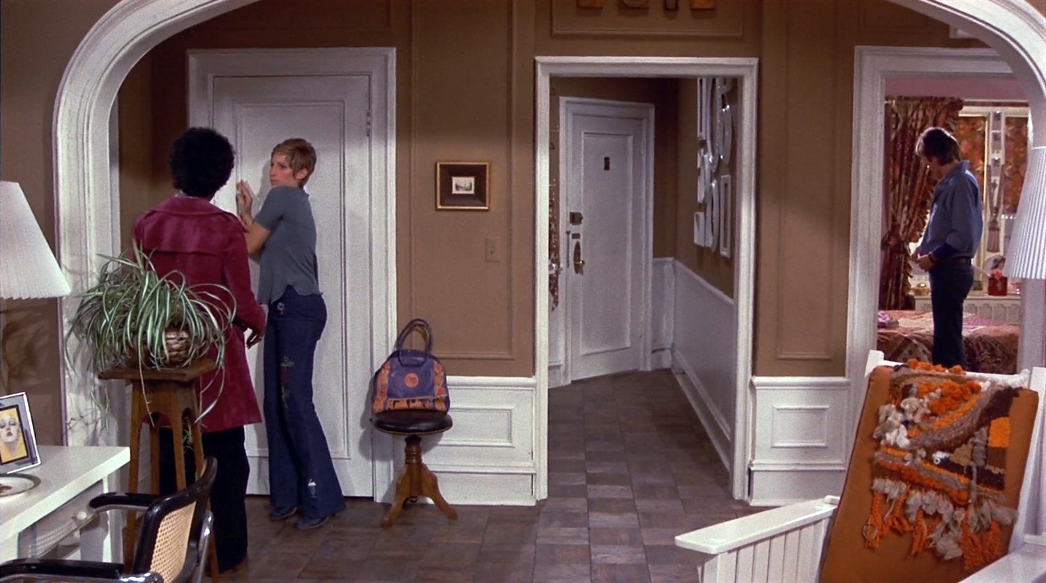 Wide shot of the apartment set, meant to function as a French farce.