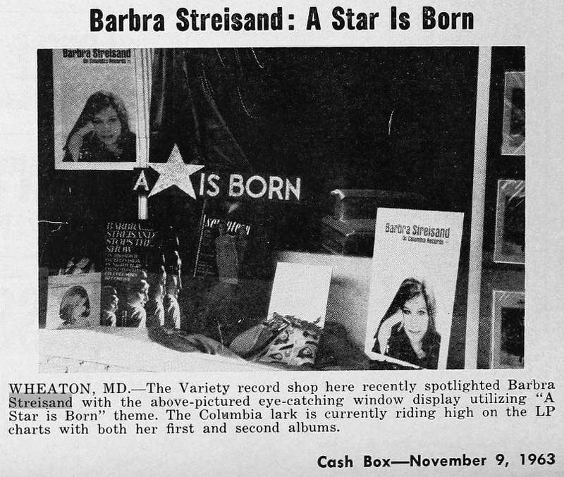 Barbra Streisand album display in a storefront window with her portrait and “A Star Is Born” signage