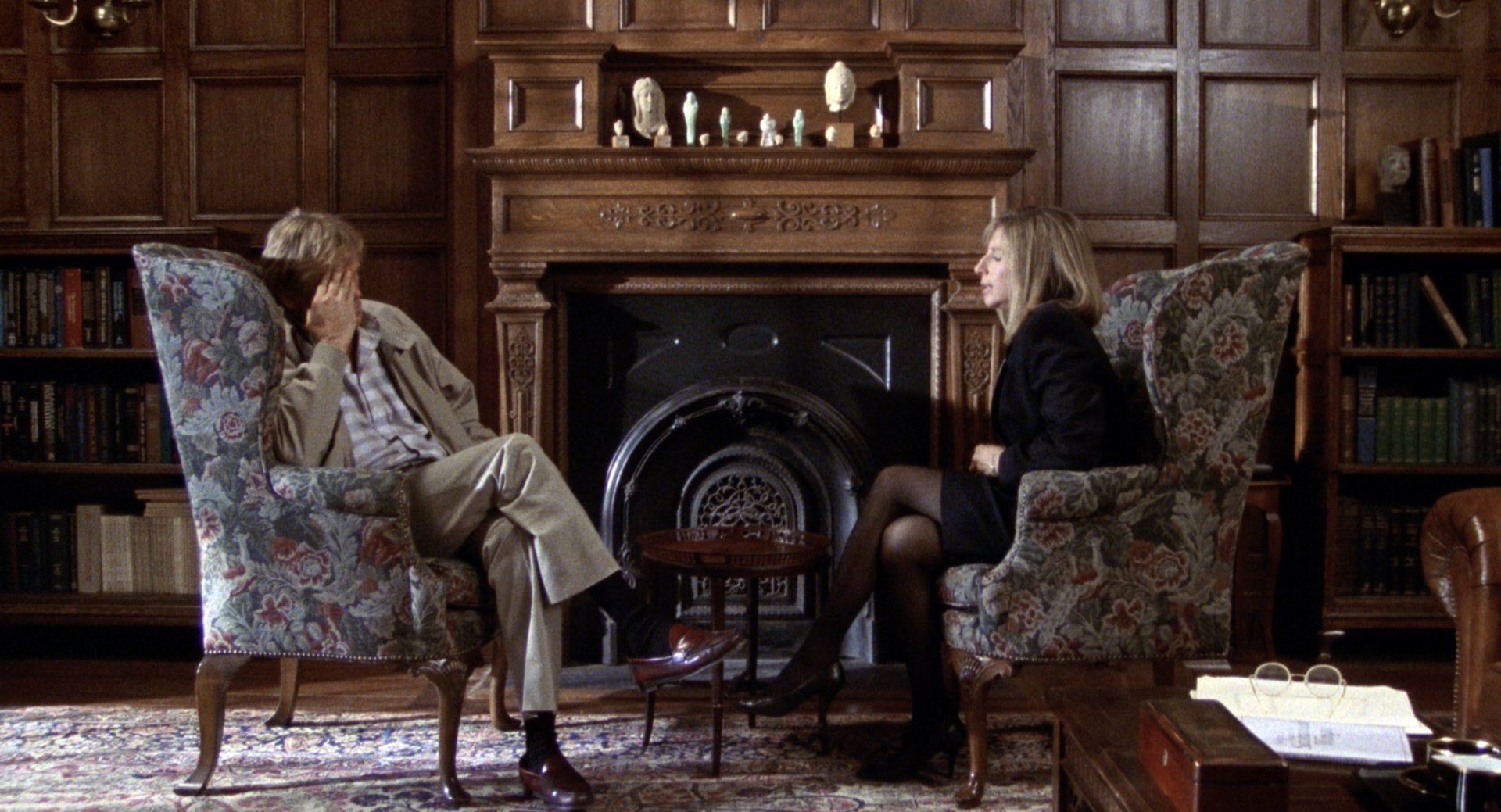 Barbra Streisand and Nick Nolte sit across from each other.