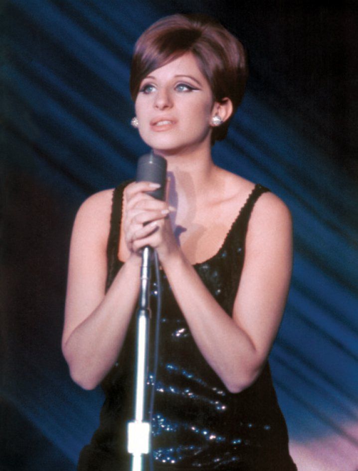 Barbra Streisand singing in black sparkly dress.