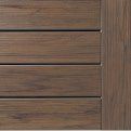 Close-up of horizontal brown wooden siding panels with a vertical trim edge