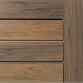 Close-up of horizontal wood planks in brown and tan tones with a dark wood edge on the right