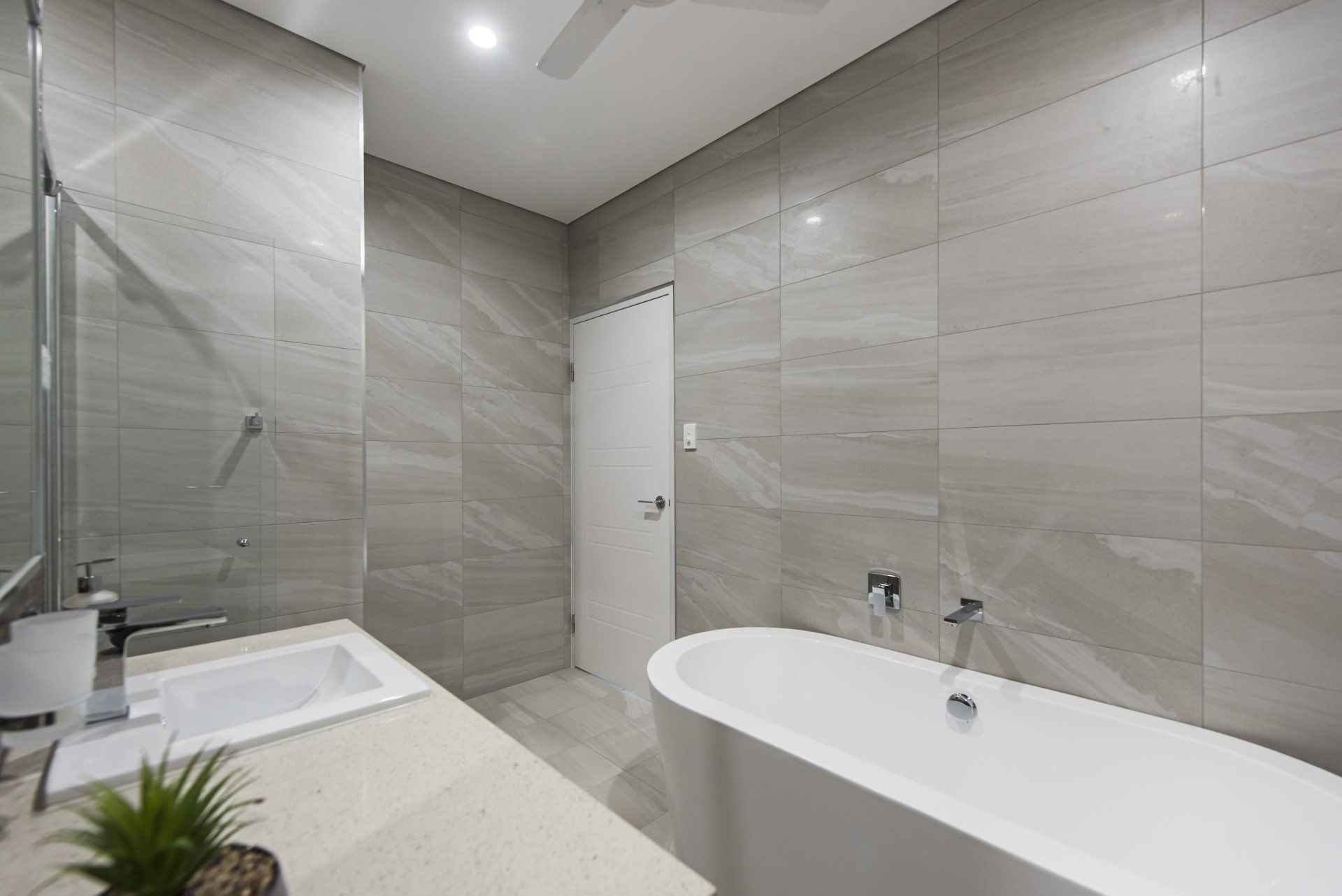 A bathroom with a bathtub , sink and shower.
