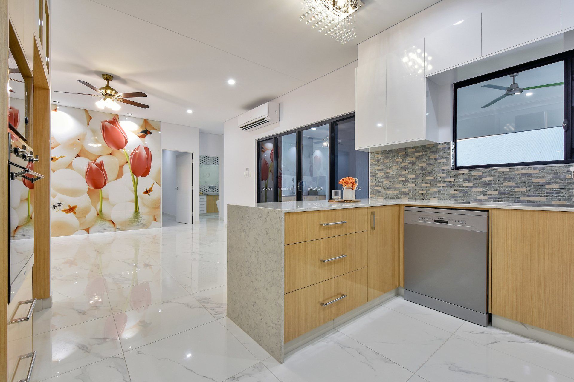 A kitchen with wooden cabinets and a stainless steel dishwasher.