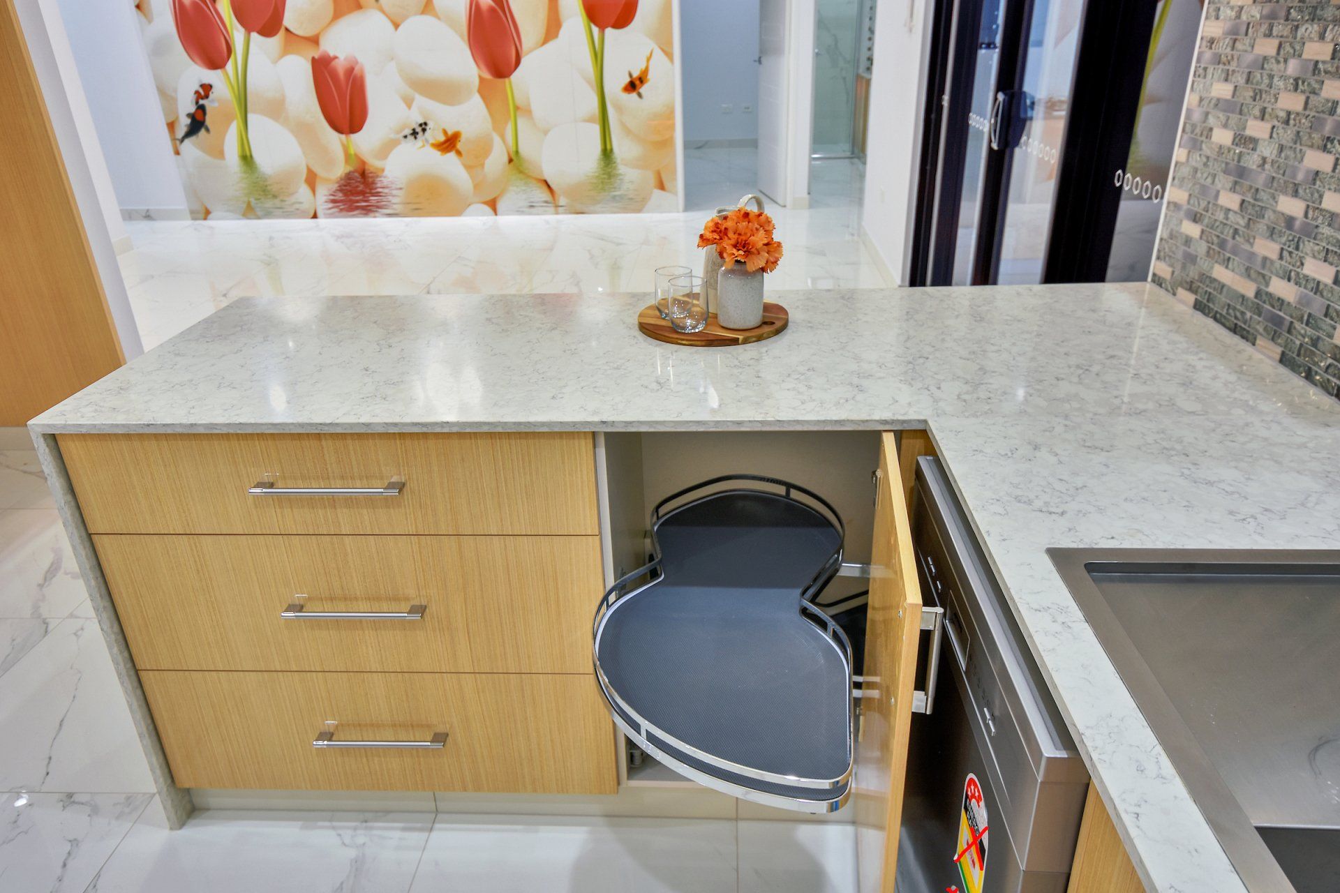 A kitchen with a heart shaped cabinet and a picture of flowers on the wall.