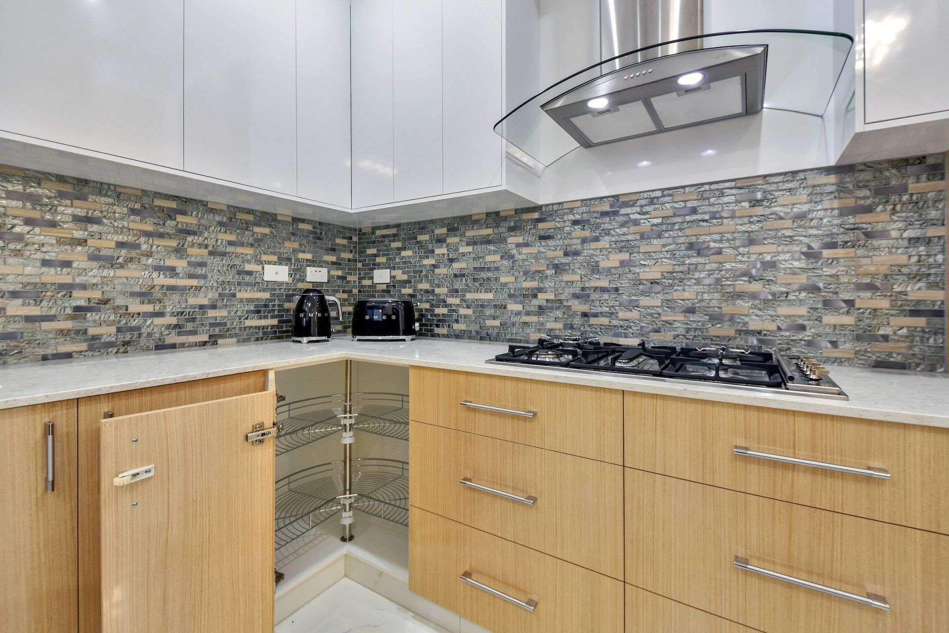 A kitchen with wooden cabinets and a stove top oven.