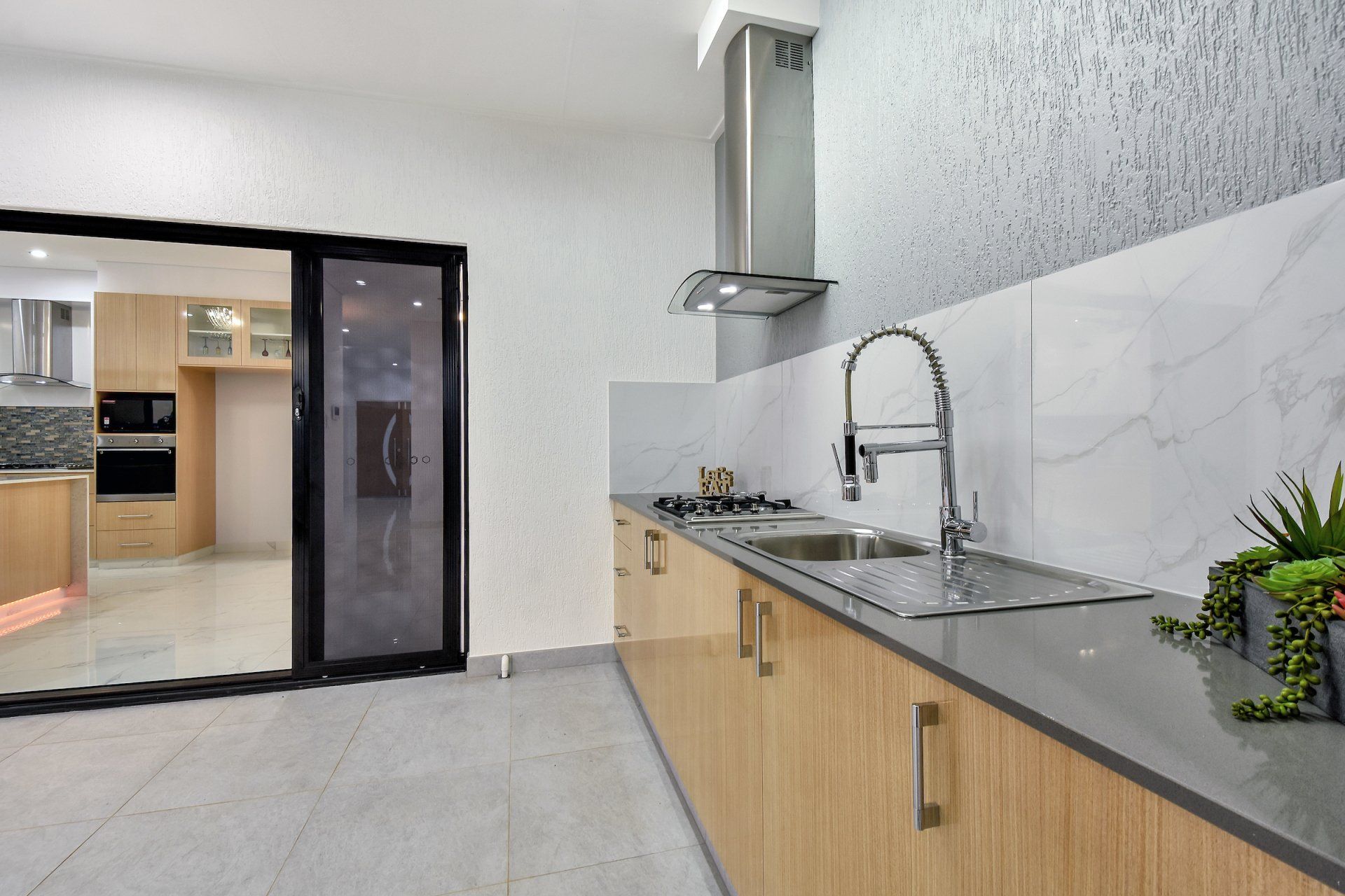 A kitchen with stainless steel appliances and wooden cabinets.