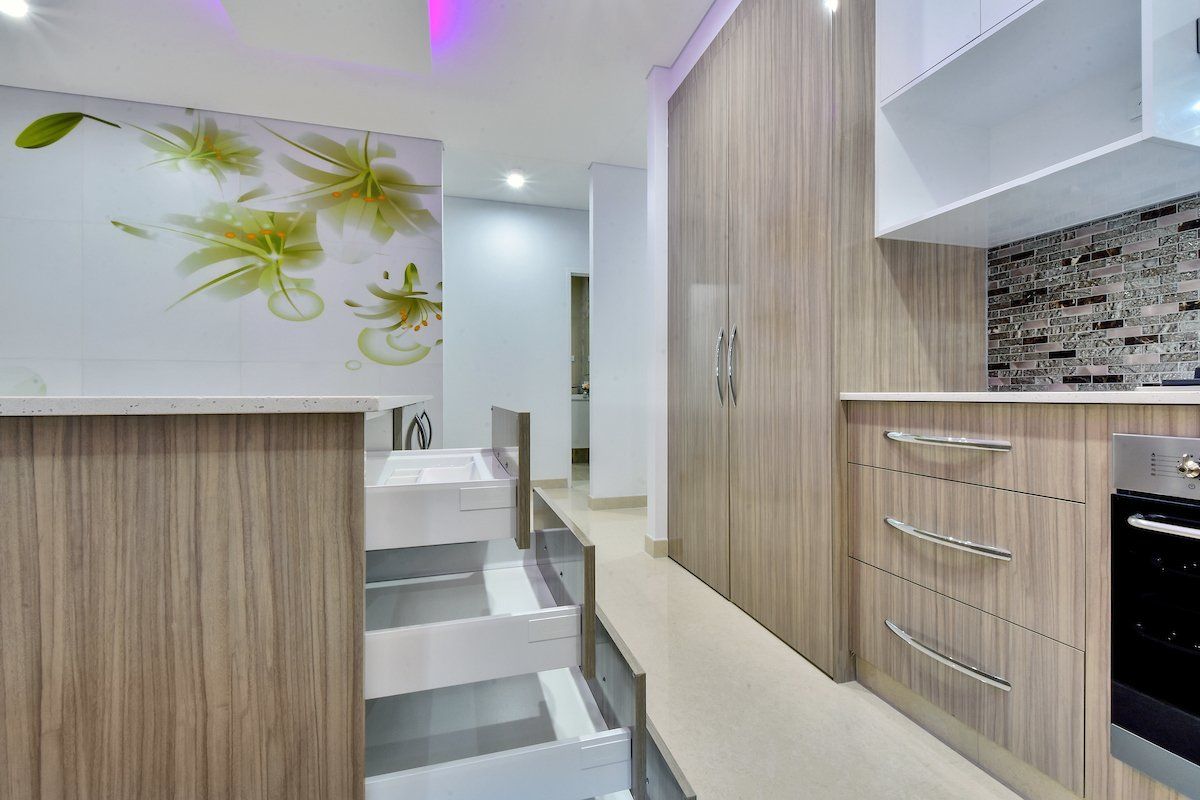A kitchen with wooden cabinets and stainless steel appliances.