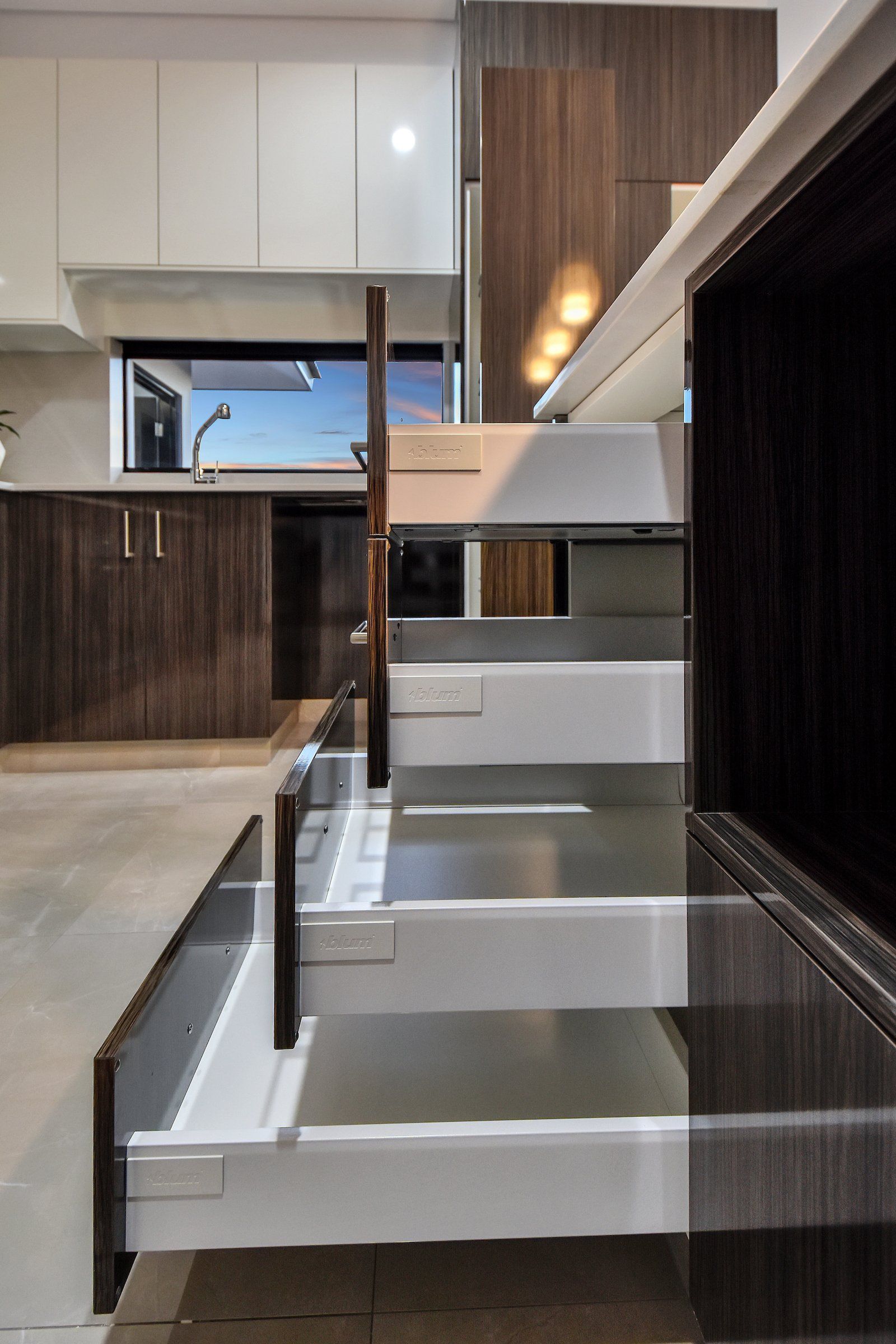 A kitchen with a lot of drawers and cabinets