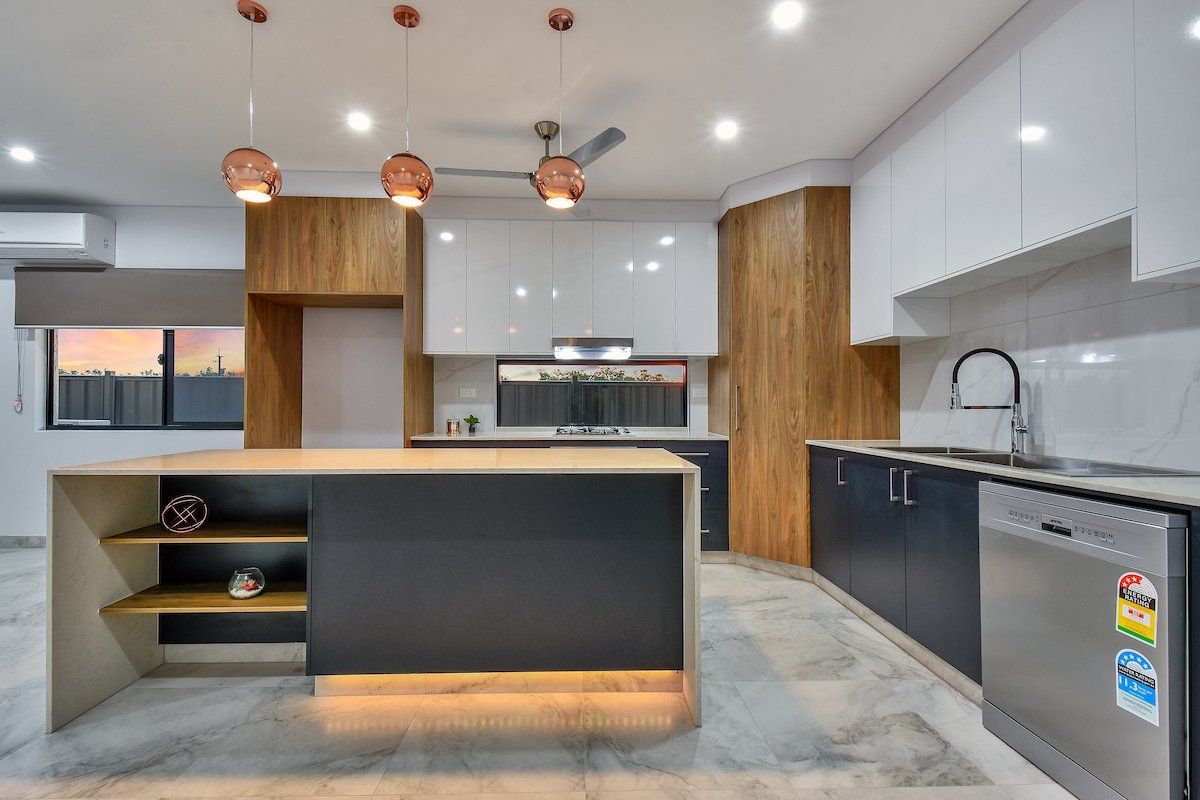A kitchen with a large island and stainless steel appliances