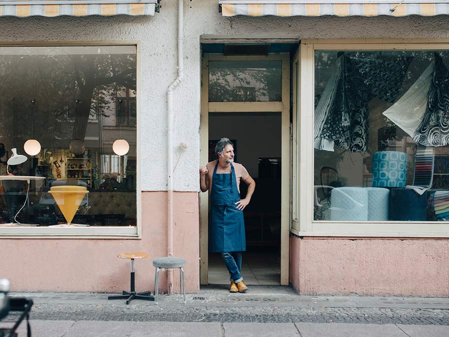 man standing outside his shop