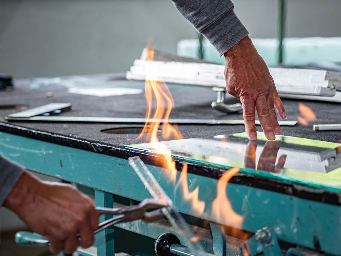 person heating glass