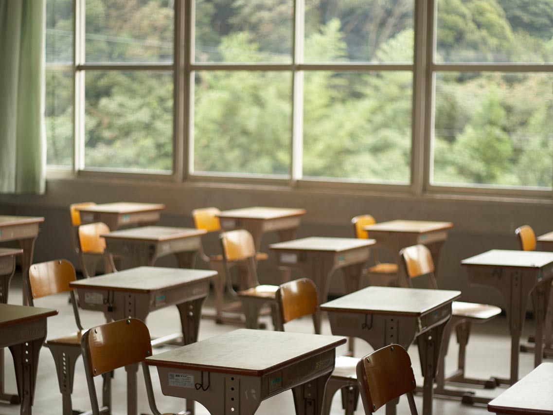 rows of school desks near a window
