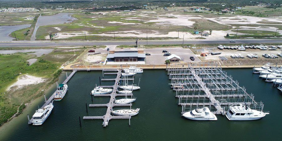 An aerial view of a marina with boats docked in it.