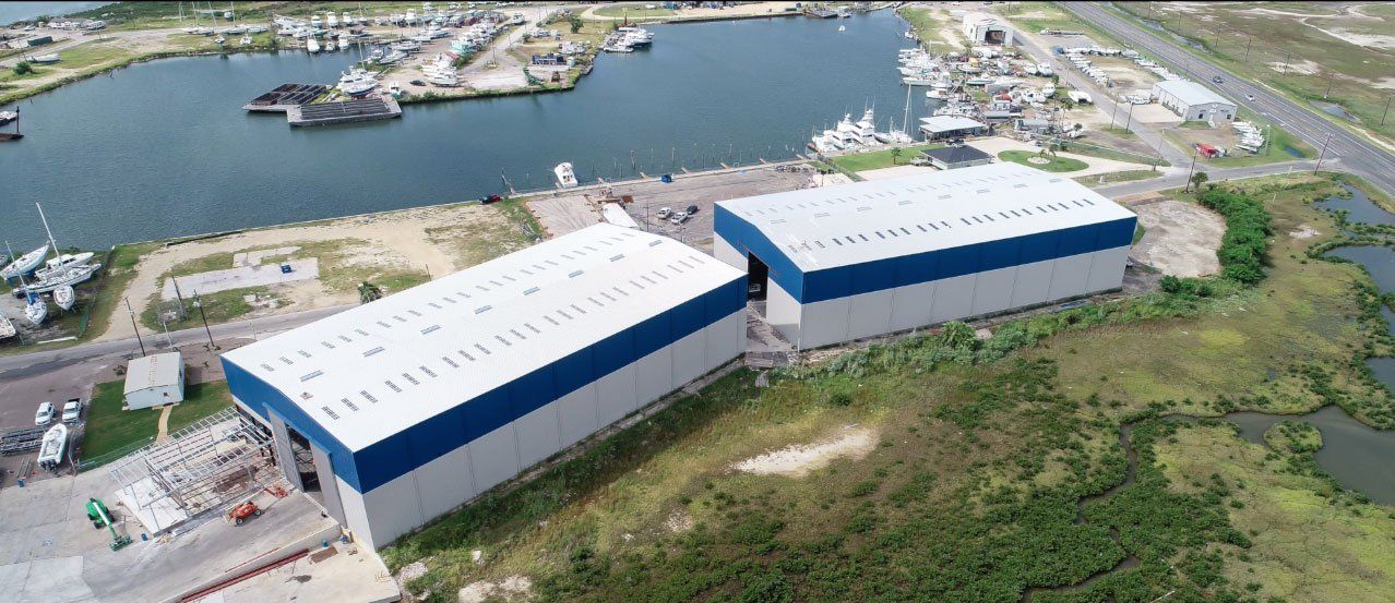 An aerial view of a large building next to a body of water.