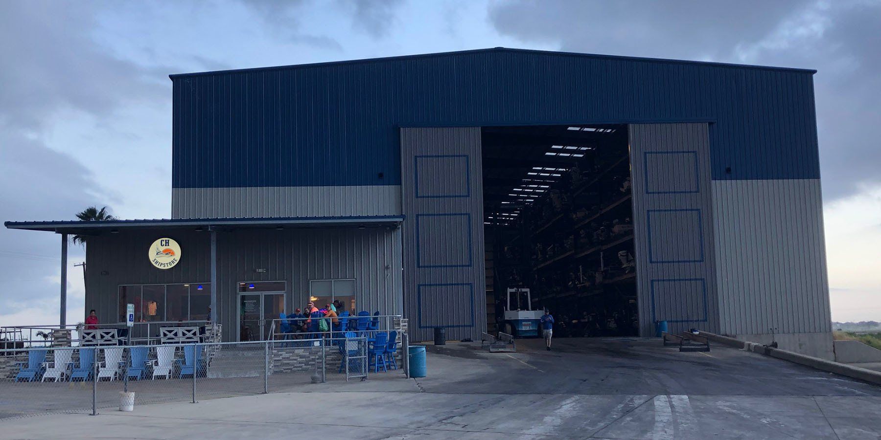 A large blue and white building with a large sliding door.
