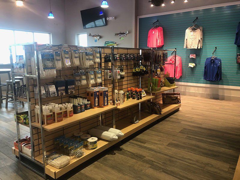 A store filled with lots of shelves and clothes hanging on the wall.