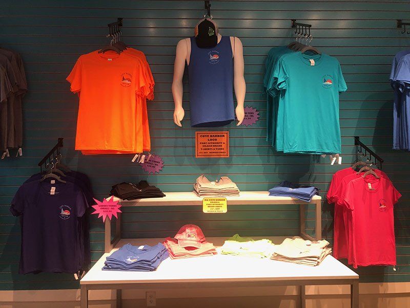 A display of t-shirts hanging on a wall in a store.