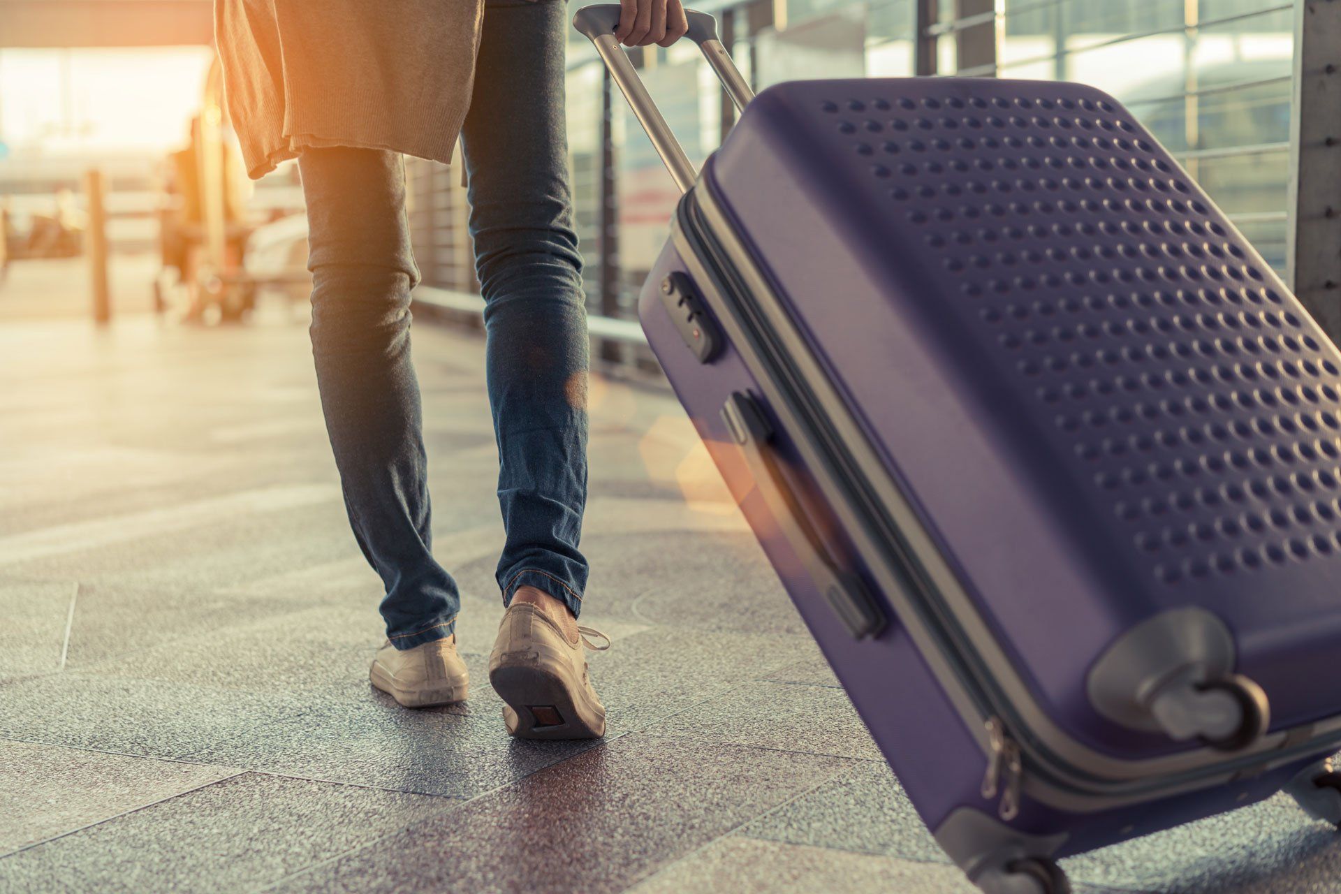 Low Section Of Woman Walking On Airport