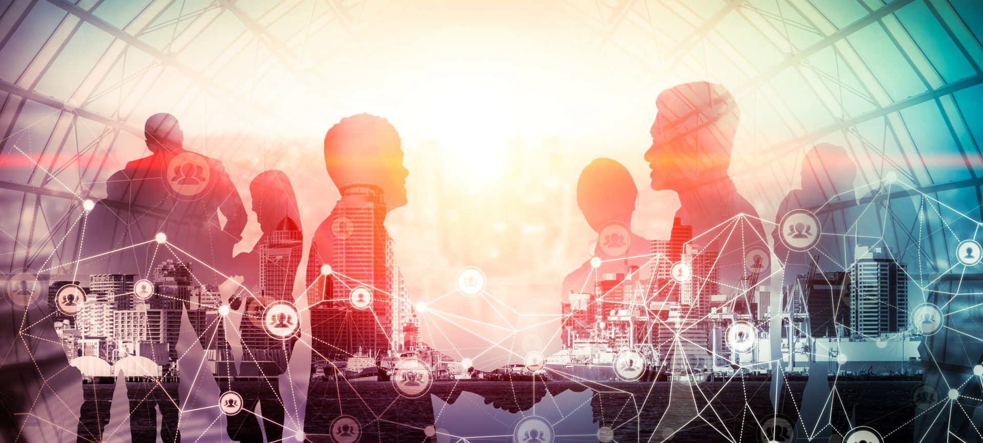 A silhouette group of are shaking hands in a room. Superimposed over them is the image of a city block, connected by lines.
